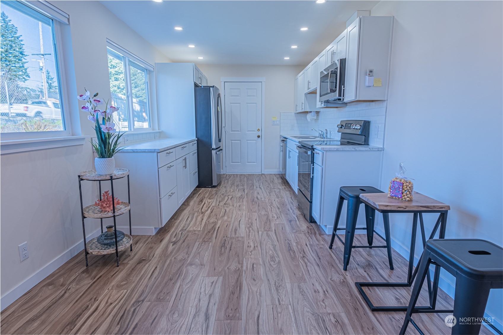 1125 Southwest 356th Street Federal Way, WA 98023 - Photo 9 of 27 a kitchen with stainless steel appliances wooden floors and wooden cabinets