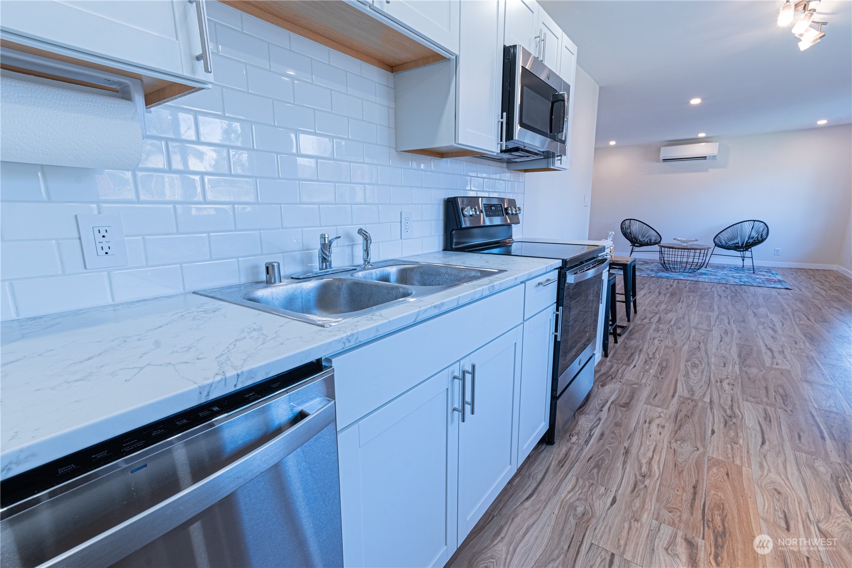 1125 Southwest 356th Street Federal Way, WA 98023 - Photo 10 of 27 a kitchen with stainless steel appliances a sink dishwasher stove and oven with wooden floor