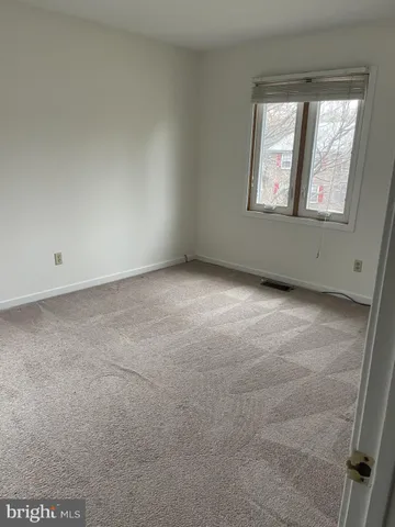 a bathroom with a granite countertop toilet and a sink
