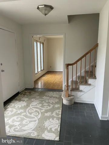 a view of an empty room with a fireplace and a window