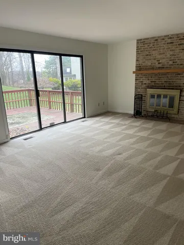 a view of a room with wooden floor and window