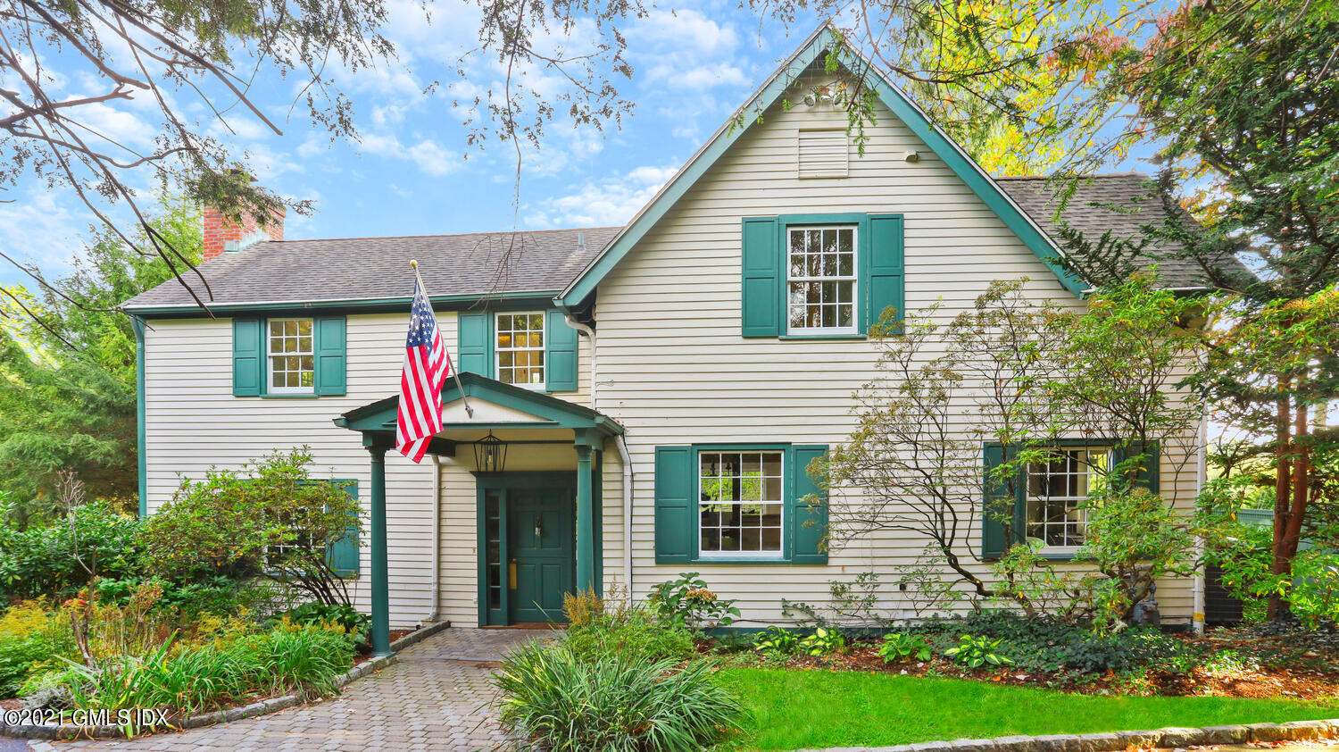 23 Parsonage Road Greenwich, CT 06830 - Photo 2 of 29 a view of a house with brick walls and potted plants