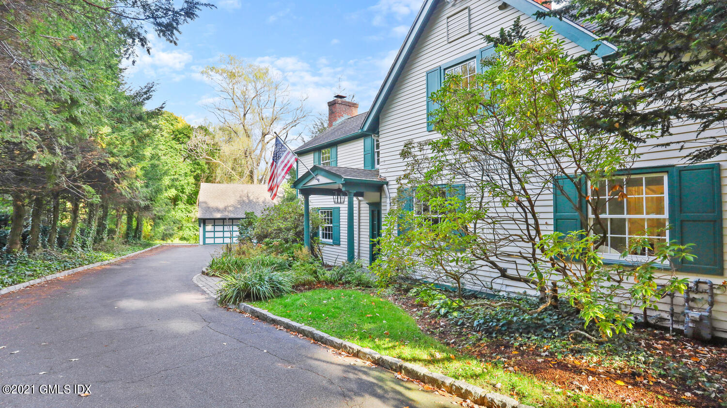 23 Parsonage Road Greenwich, CT 06830 - Photo 3 of 29 a front view of a house with a yard and fountain in middle