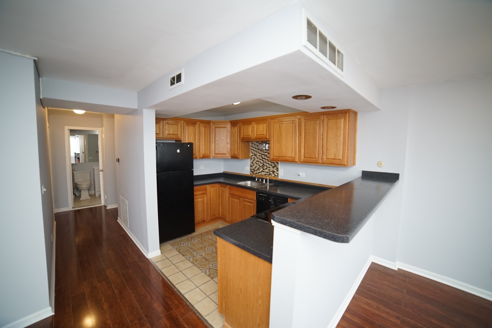 6301 North Sheridan Road, Unit 23V Chicago, IL 60660 - Photo 11 of 22 a kitchen with stainless steel appliances granite countertop a sink a stove and a refrigerator