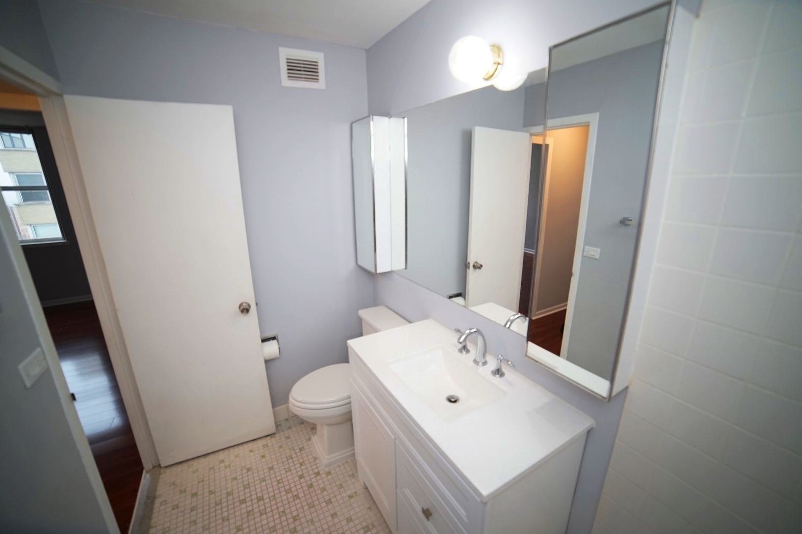 6301 North Sheridan Road, Unit 23V Chicago, IL 60660 - Photo 15 of 22 a bathroom with a sink a toilet and mirror