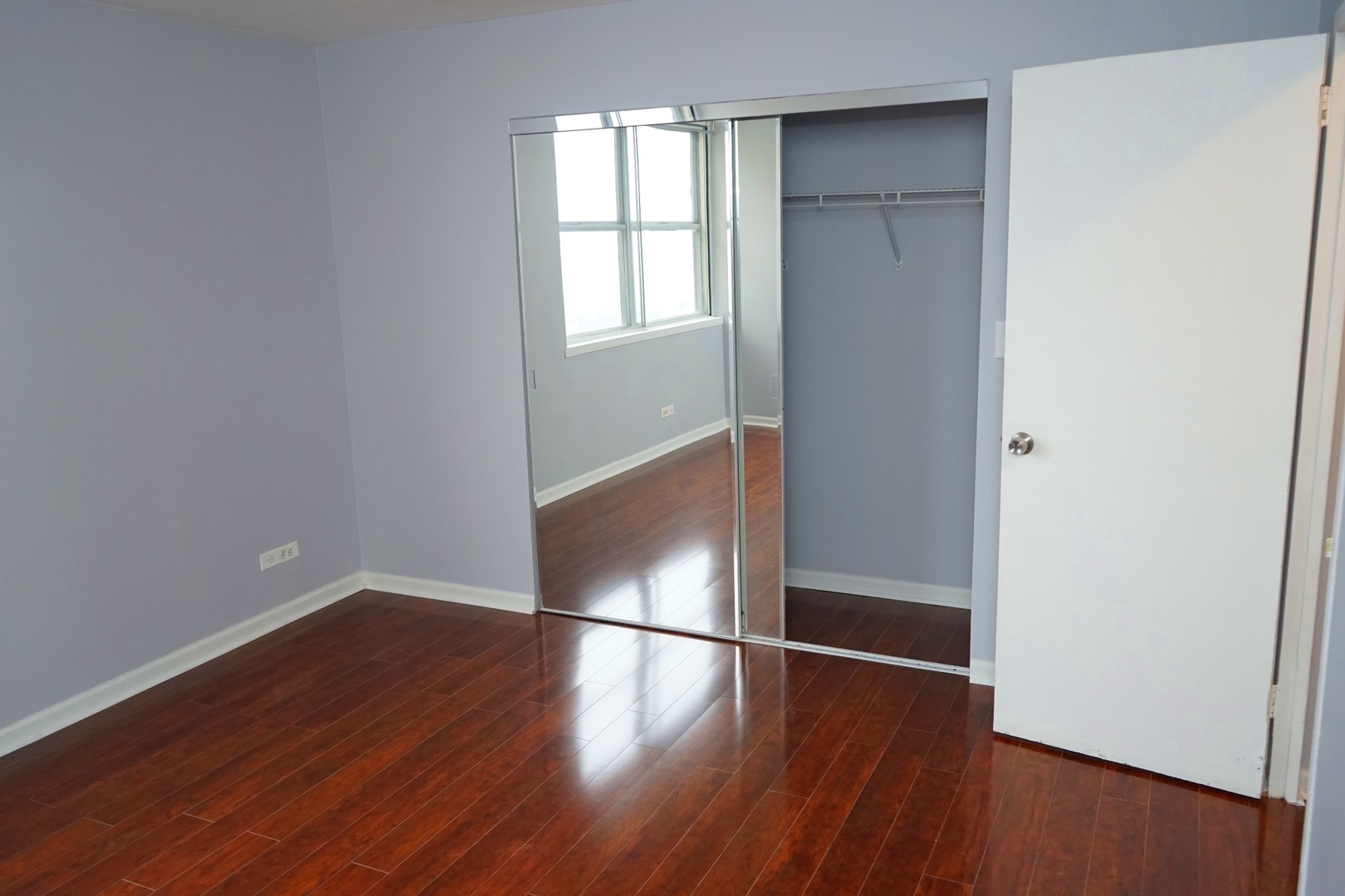 6301 North Sheridan Road, Unit 23V Chicago, IL 60660 - Photo 16 of 22 an empty room with wooden floor and windows
