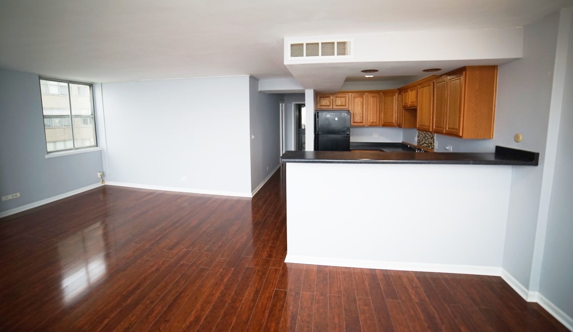 6301 North Sheridan Road, Unit 23V Chicago, IL 60660 - Photo 21 of 22 a view of a kitchen with wooden floor and a sink