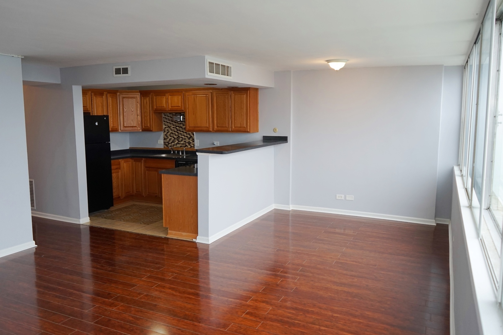 6301 North Sheridan Road, Unit 23V Chicago, IL 60660 - Photo 8 of 22 a view of a kitchen with wooden floor and electronic appliances
