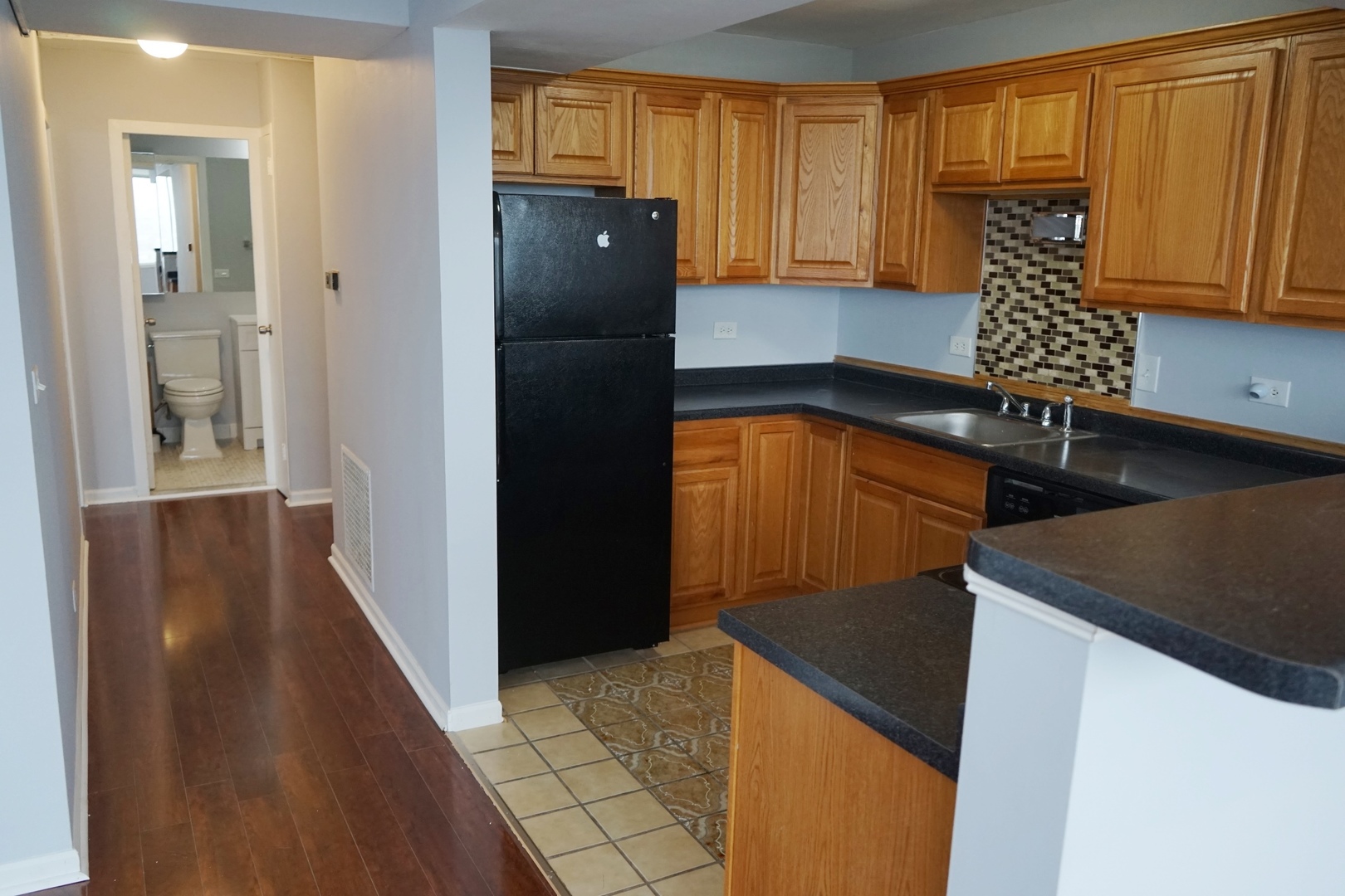 6301 North Sheridan Road, Unit 23V Chicago, IL 60660 - Photo 9 of 22 a kitchen with a refrigerator and a cabinets