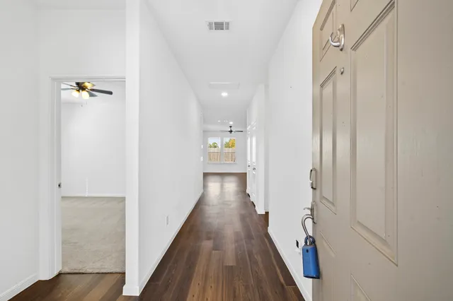 a view of hallway with wooden floor