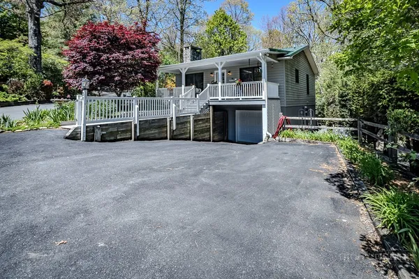 a view of a house with a yard and garage