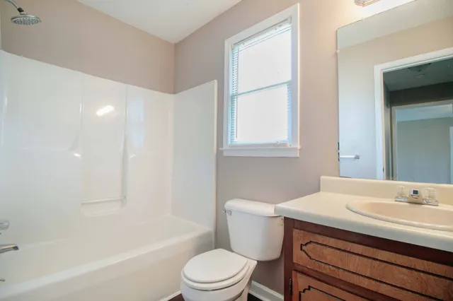 a bathroom with a sink toilet vanity and bathtub