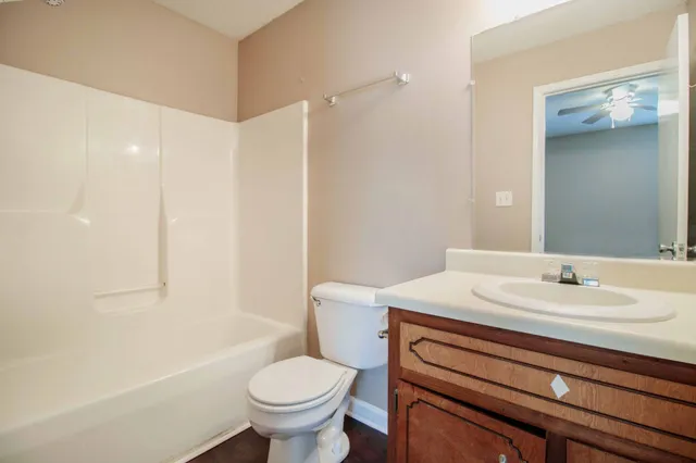 a bathroom with a sink toilet vanity and shower