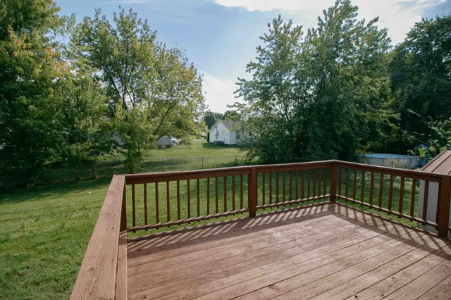 a view of balcony with wooden floor and fence