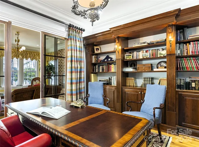 a living room with furniture fireplace and a large window