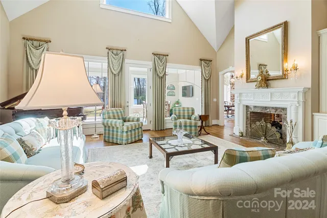 a view of a dining room with furniture a chandelier and wooden floor