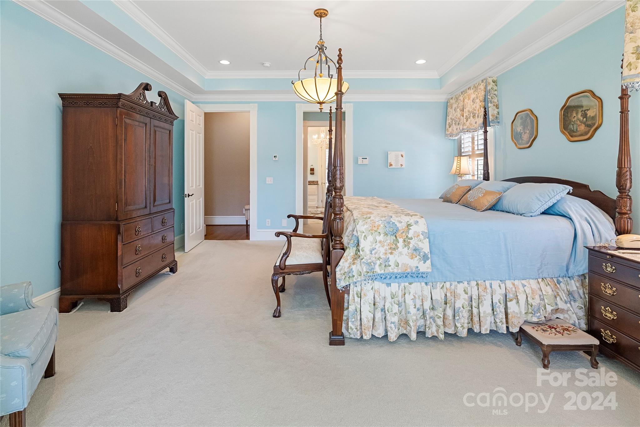 229 Joseph Kershaw Road Eastover, SC 29044 - Photo 32 of 48 a bedroom with a bed and a chandelier