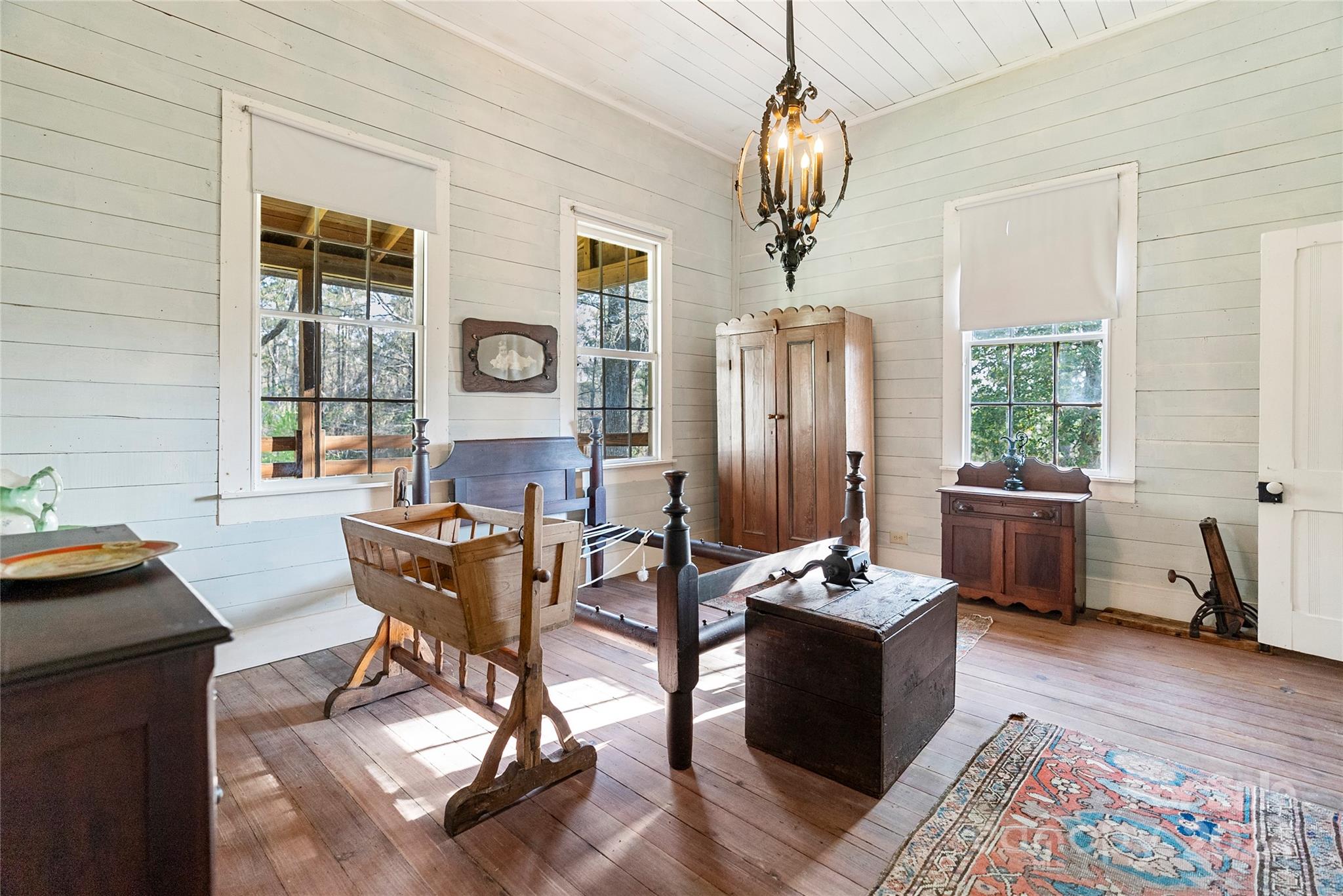 229 Joseph Kershaw Road Eastover, SC 29044 - Photo 38 of 48 a living room with furniture a window and a chandelier