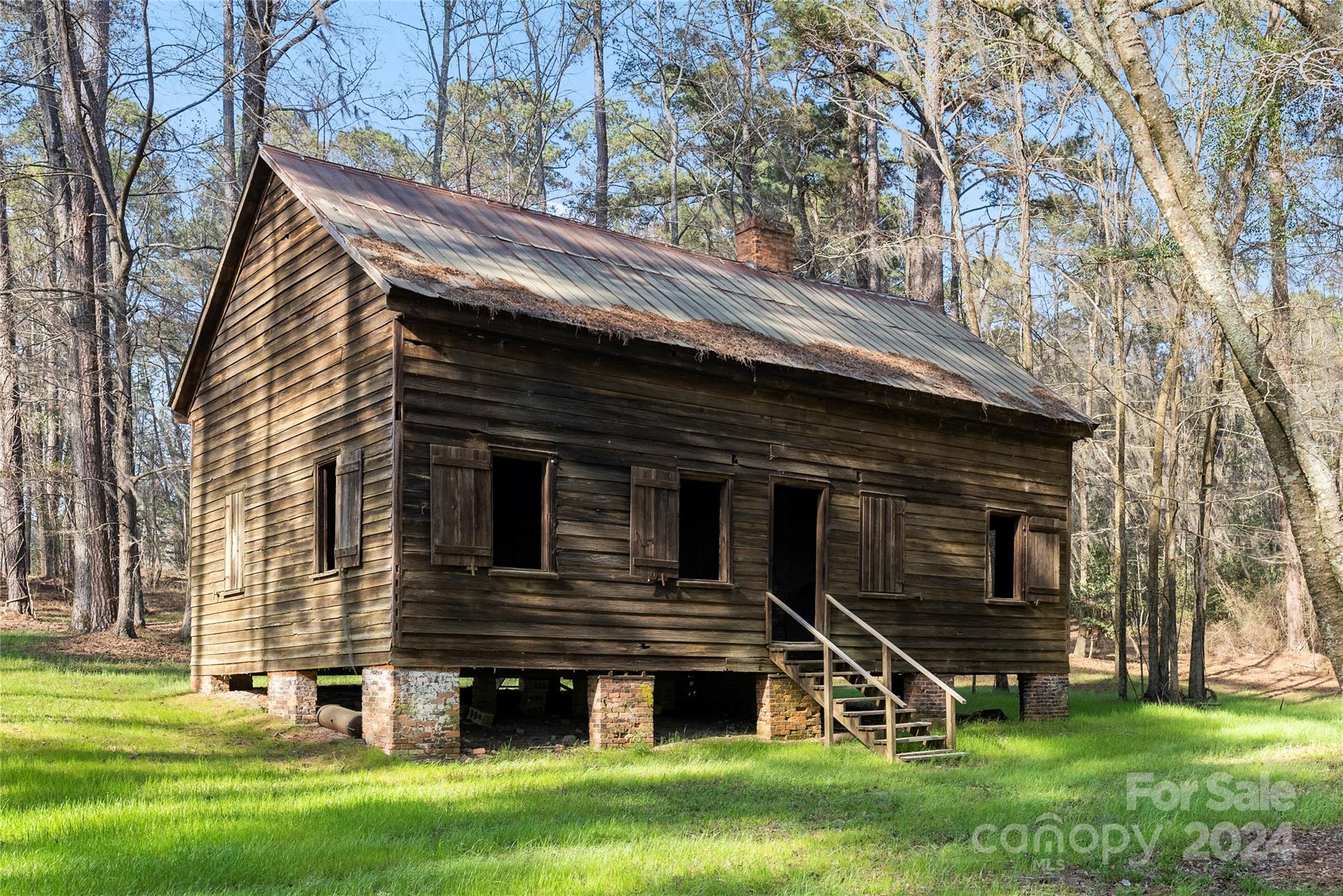 229 Joseph Kershaw Road Eastover, SC 29044 - Photo 42 of 48 a view of a house with a large window and a yard