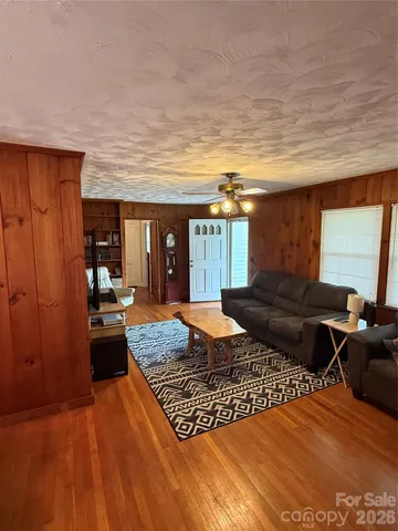a living room with furniture a rug and a large window