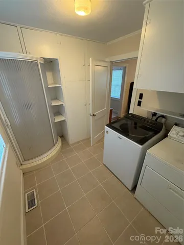 a bedroom with a bed and a lamp on the dresser