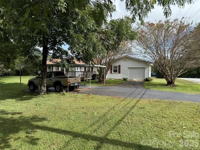 a view of house with yard in front of house