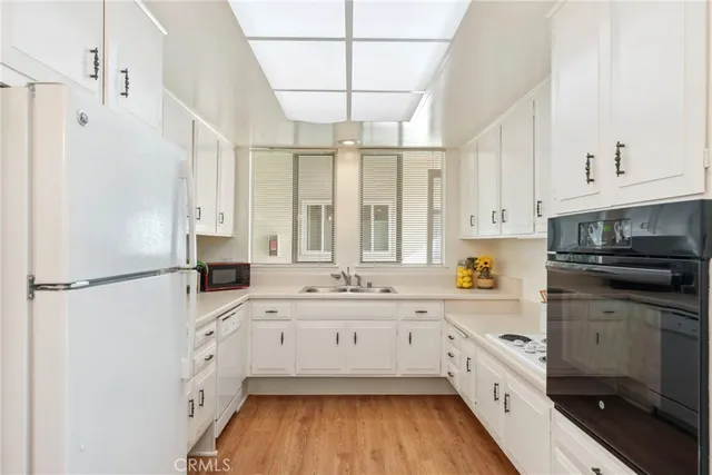a living room with furniture large window and wooden floor