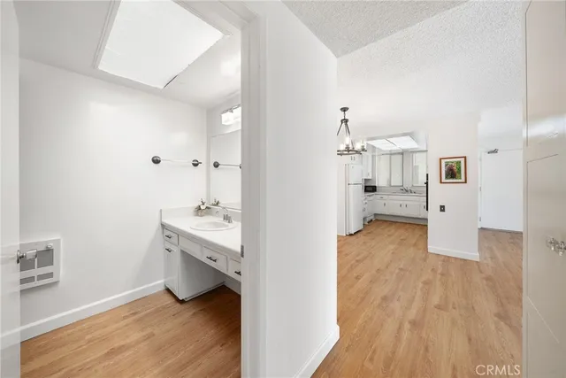 a kitchen with granite countertop a sink cabinets and stainless steel appliances