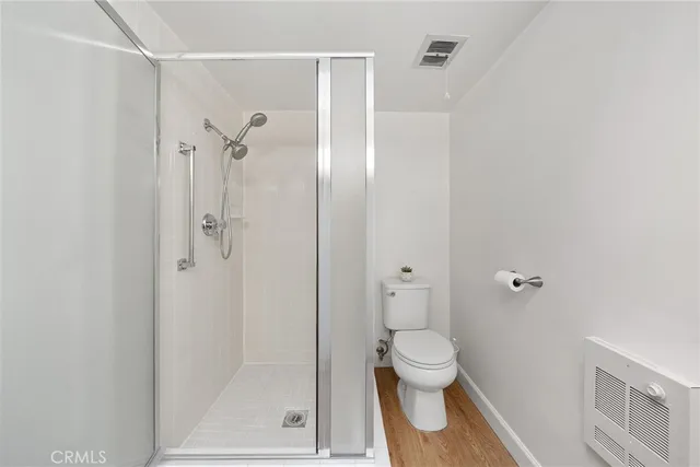 a view of a bathroom with sink wooden floor and windows