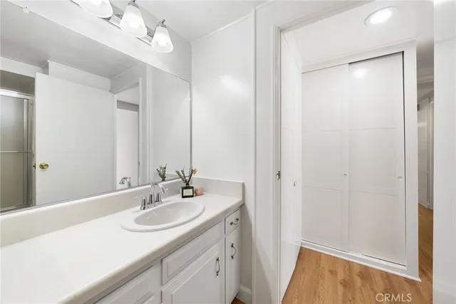 a bathroom with a sink a toilet a mirror and shower