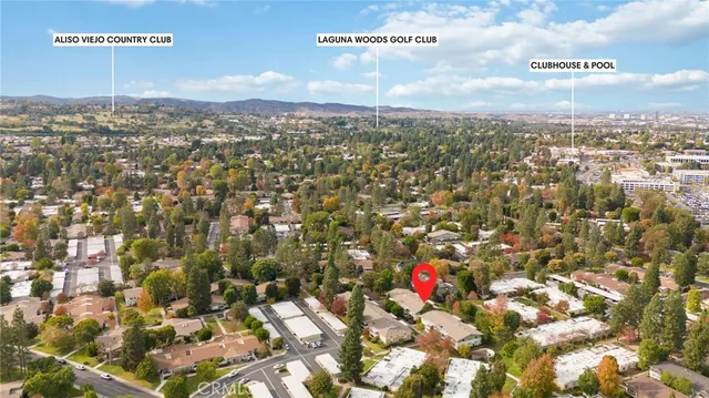 an aerial view of residential houses with city view