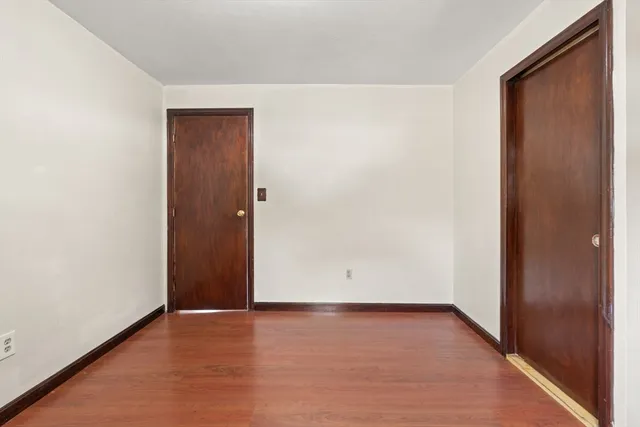 a spacious bedroom with a bed and a flat screen tv