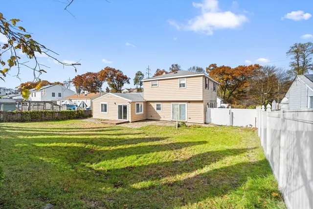 an aerial view of residential houses with outdoor space and parking