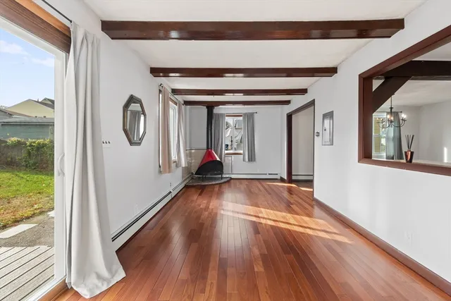 a view of a hallway with wooden floor and a large window