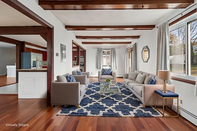 a view of a kitchen with granite countertop center island wooden floor and a chandelier