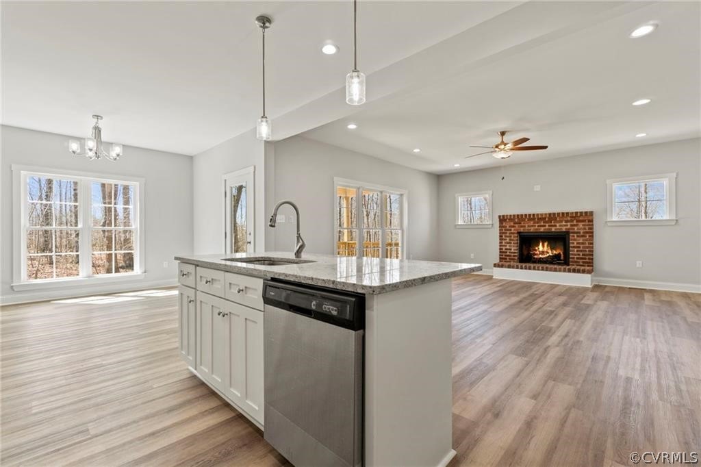 2148 Sandy Hook Road Goochland, VA 23063 - Photo 13 of 34 a kitchen with stainless steel appliances granite countertop a sink a stove and a wooden floors