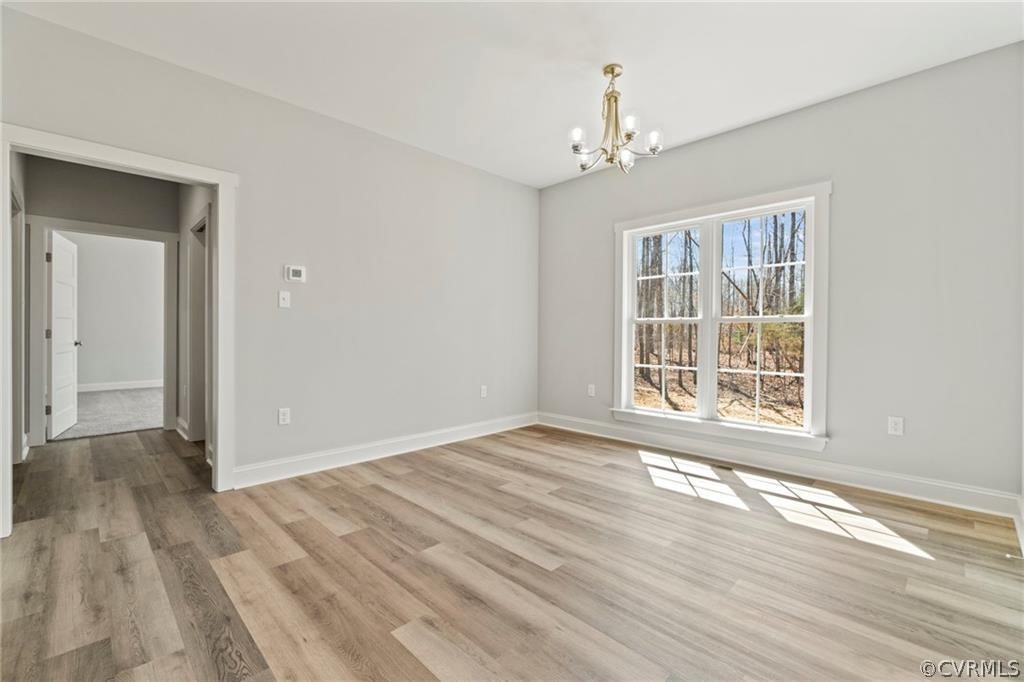 2148 Sandy Hook Road Goochland, VA 23063 - Photo 14 of 34 a view of an empty room with wooden floor and a window