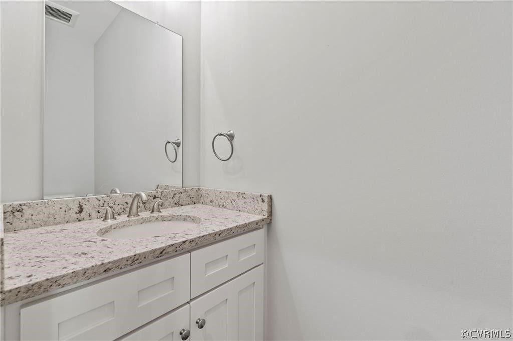 2148 Sandy Hook Road Goochland, VA 23063 - Photo 16 of 34 a bathroom with a granite countertop sink and a mirror