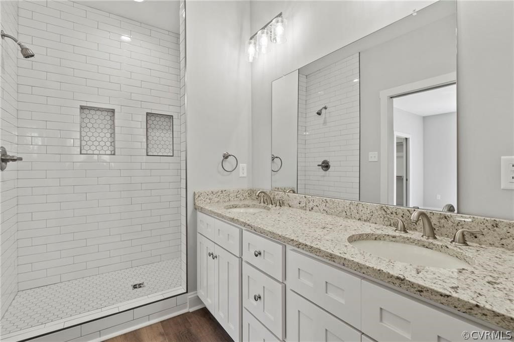 2148 Sandy Hook Road Goochland, VA 23063 - Photo 17 of 34 a bathroom with a granite countertop sink a shower and a mirror