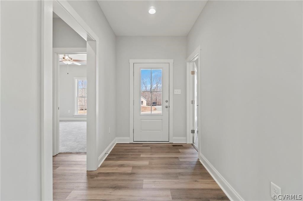 2148 Sandy Hook Road Goochland, VA 23063 - Photo 4 of 34 a view of a hallway with wooden floor and a bathroom