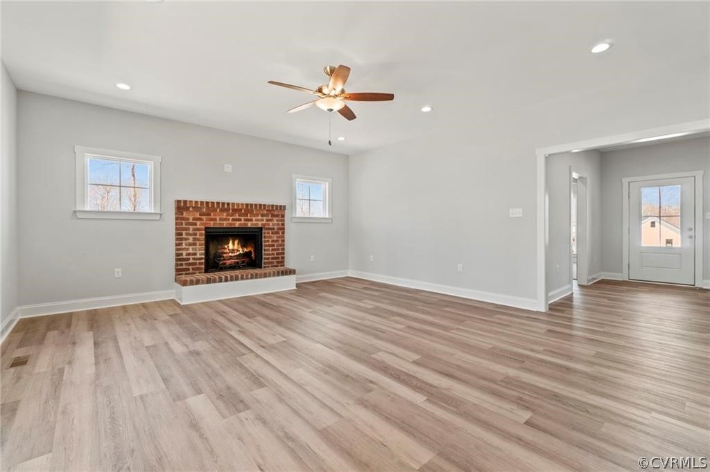 2148 Sandy Hook Road Goochland, VA 23063 - Photo 7 of 34 a view of empty room with wooden floor fireplace and a window