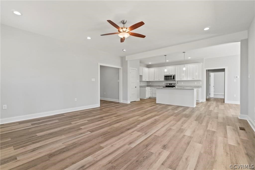 2148 Sandy Hook Road Goochland, VA 23063 - Photo 8 of 34 a view of a kitchen with a sink dishwasher a kitchen island with wooden floor and cabinets