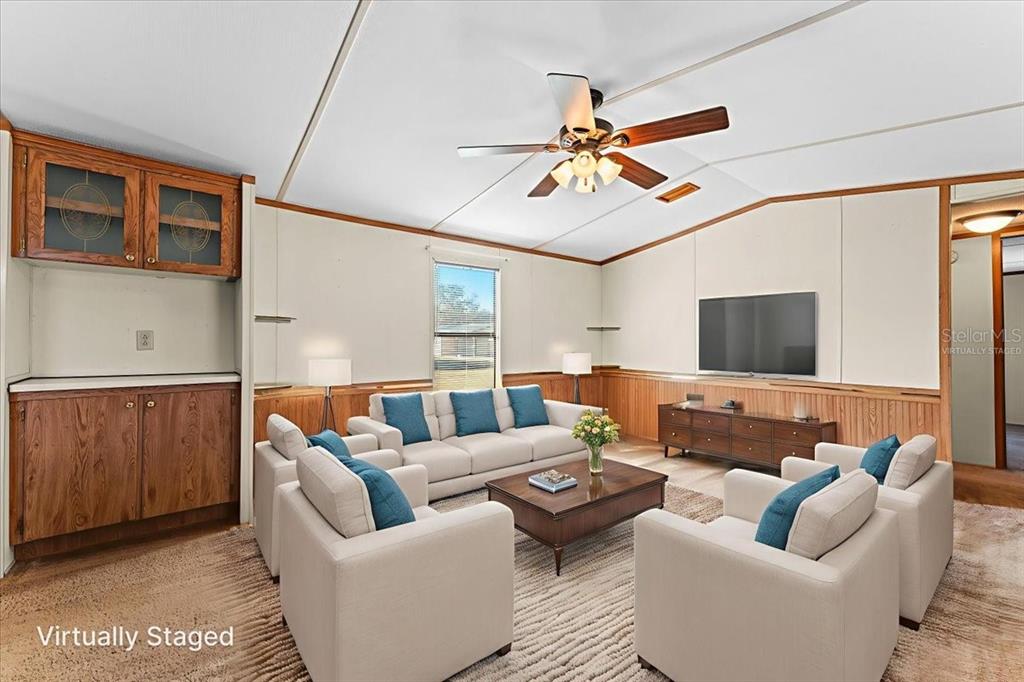 12001 Rhodine Road Riverview, FL 33579 - Photo 13 of 61 a living room with furniture and a flat screen tv