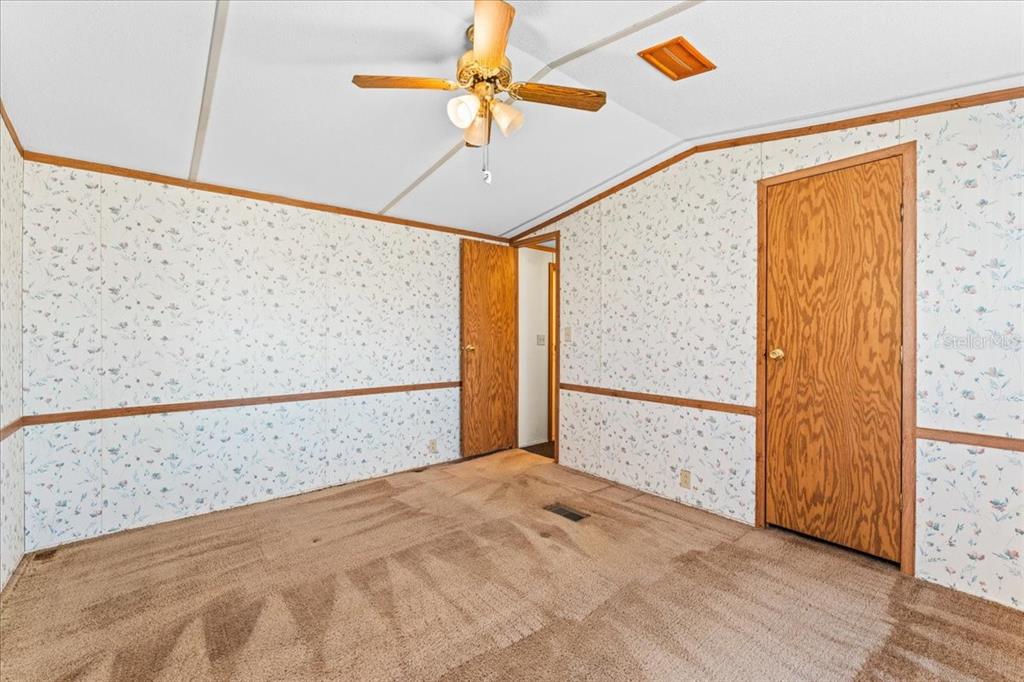 12001 Rhodine Road Riverview, FL 33579 - Photo 22 of 61 a view of a room with wooden floor and a ceiling fan