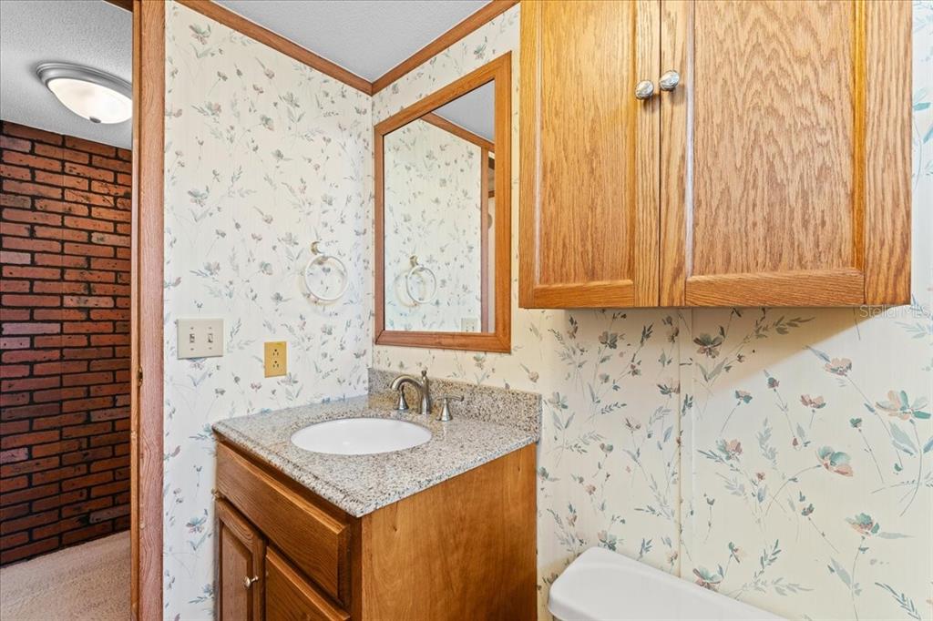 12001 Rhodine Road Riverview, FL 33579 - Photo 32 of 61 a bathroom with a sink toilet and shower