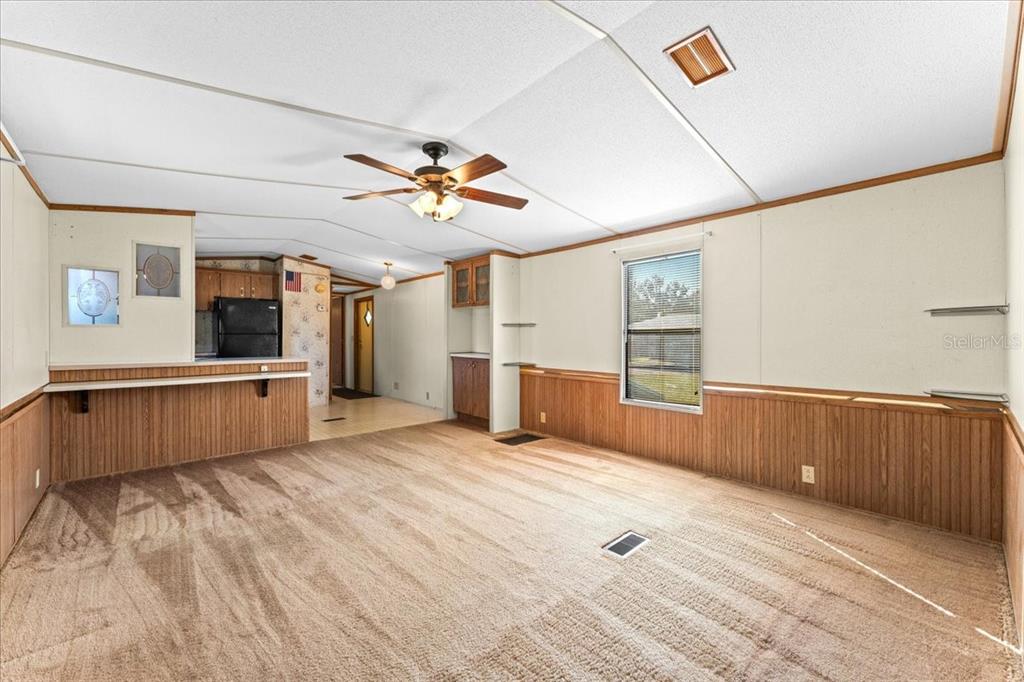 12001 Rhodine Road Riverview, FL 33579 - Photo 10 of 61 a large kitchen with stainless steel appliances a large counter top a stove and a chandelier