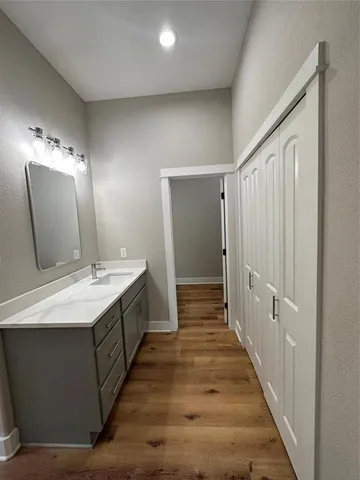 a spacious bathroom with a double vanity sink and mirror