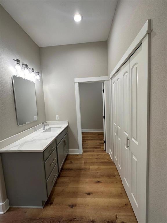 911 Nata Lane Dallas, TX 75253 - Photo 4 of 7 a spacious bathroom with a double vanity sink and mirror