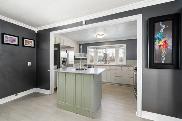 a kitchen with stainless steel appliances granite countertop a sink and refrigerator