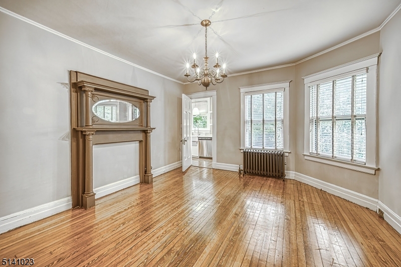 42 Gates Avenue Montclair, NJ 07042 - Photo 12 of 44 an empty room with wooden floor cabinet and windows